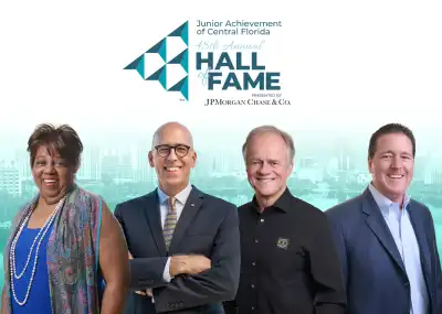 Four individuals against the backdrop of Lake Eola